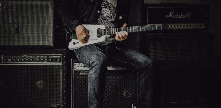 rockeiro sentado tocando guitarra